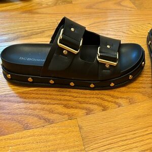 BCBGeneration Black Sandals with Gold Details